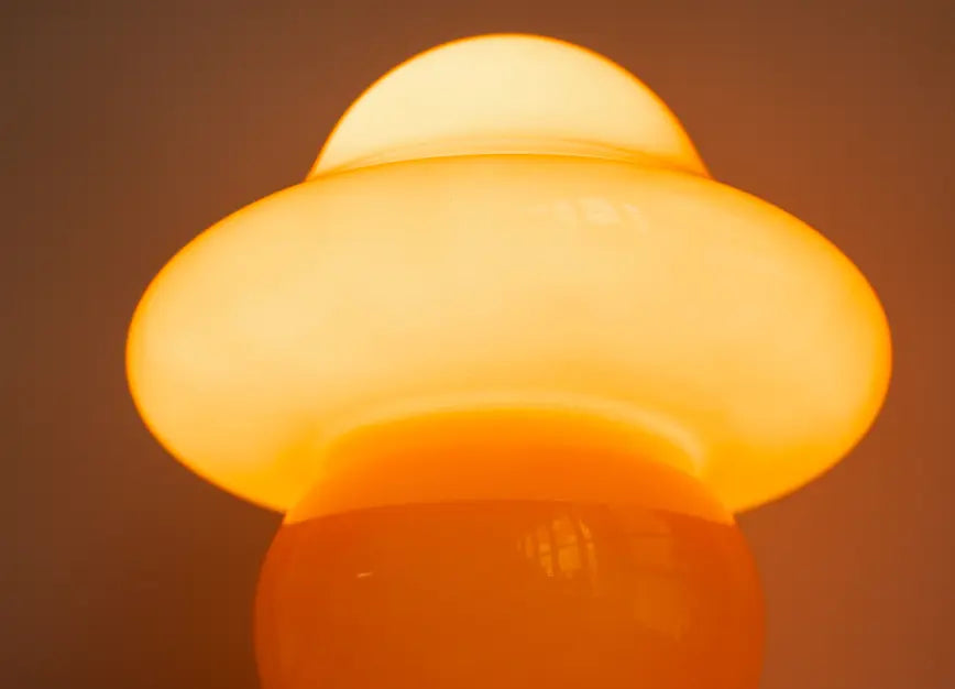 Mini Mushroom Orange Glass Table Lamp glowing with warm ambient light
