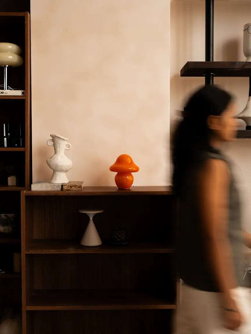 Mini Mushroom Orange Glass Table Lamp styled on a modern living room shelf