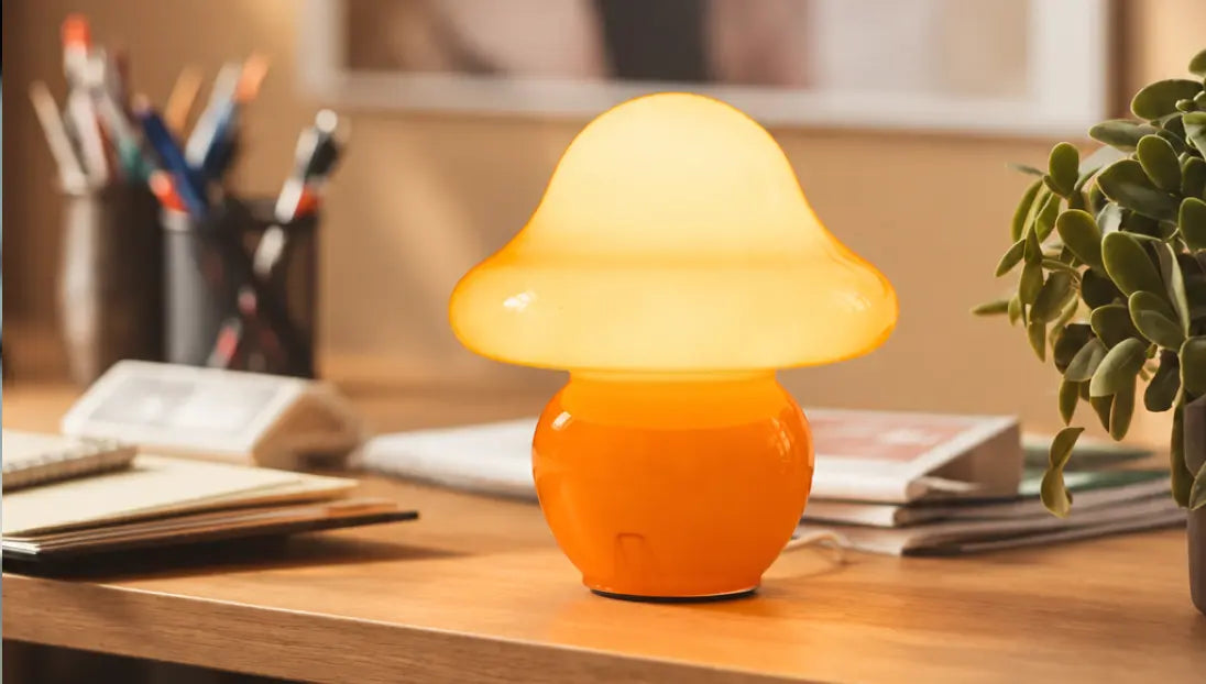 Mini Mushroom Orange Glass Table Lamp glowing on a modern study desk