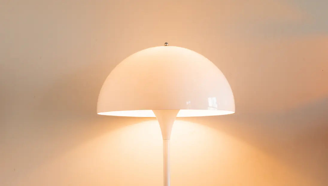 Front view of Nova white floor lamp with a glowing dome shade and slender stem