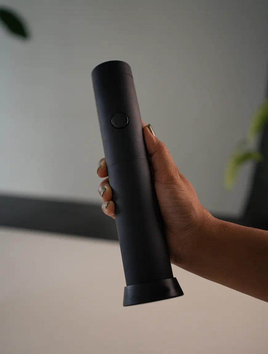 Hand holding the Twist Milk Frother, demonstrating its lightweight and comfortable grip.